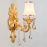 Gold single light sconce with an opal glass shade, studio view