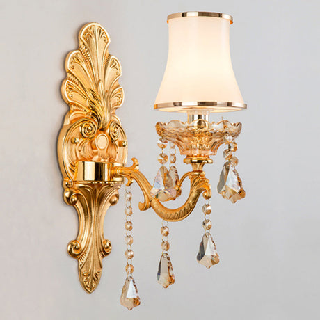 Gold single light sconce with an opal glass shade, studio view