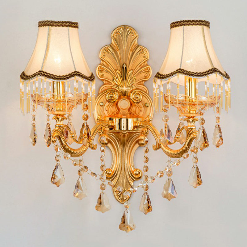 Gold two light sconce with fabric shades and layered crystal strands