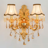 Gold two light sconce with fabric shades and layered crystal strands
