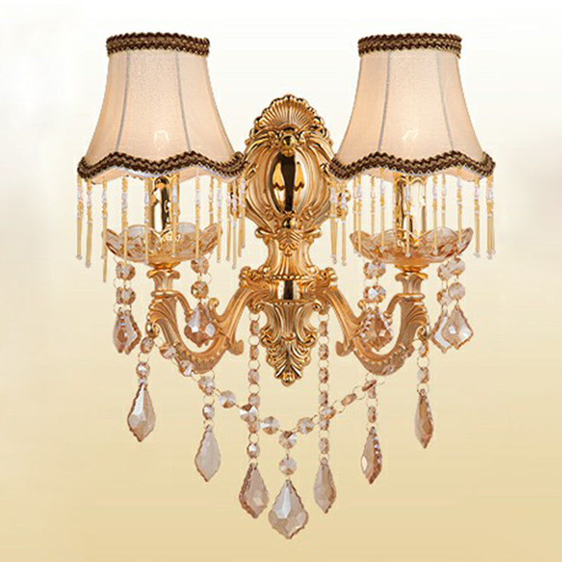 Gold two light sconce with fringed fabric shades and crystal drops