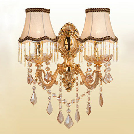 Gold two light sconce with fringed fabric shades and crystal drops