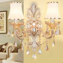 Silver sconce with pleated shades lighting a traditional living room