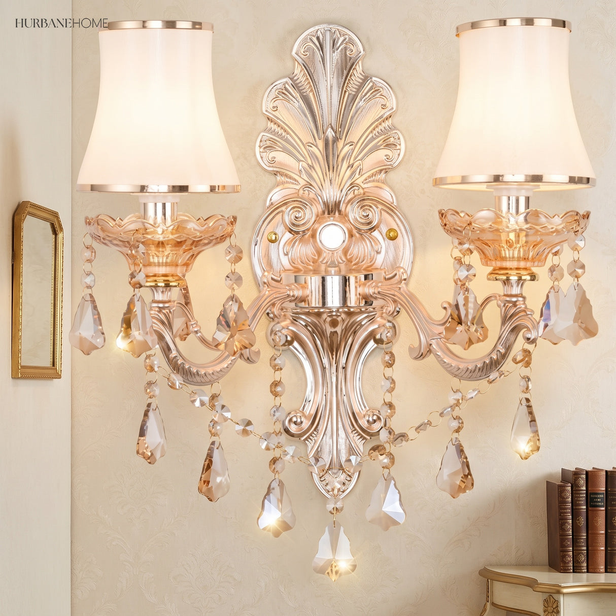 Silver candelabra sconce with white shades on a pale plaster wall