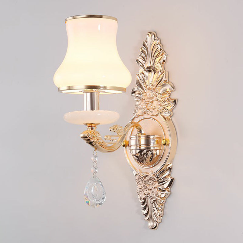 Silver scrolled backplate sconce with a bell shaped opal glass shade