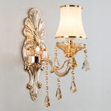 Silver single light sconce with an opal glass shade, studio view