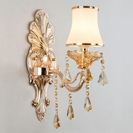 Silver single light sconce with an opal glass shade, studio view