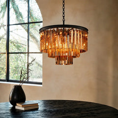 Close view of faceted crystal prisms hanging from the chandelier metal frame