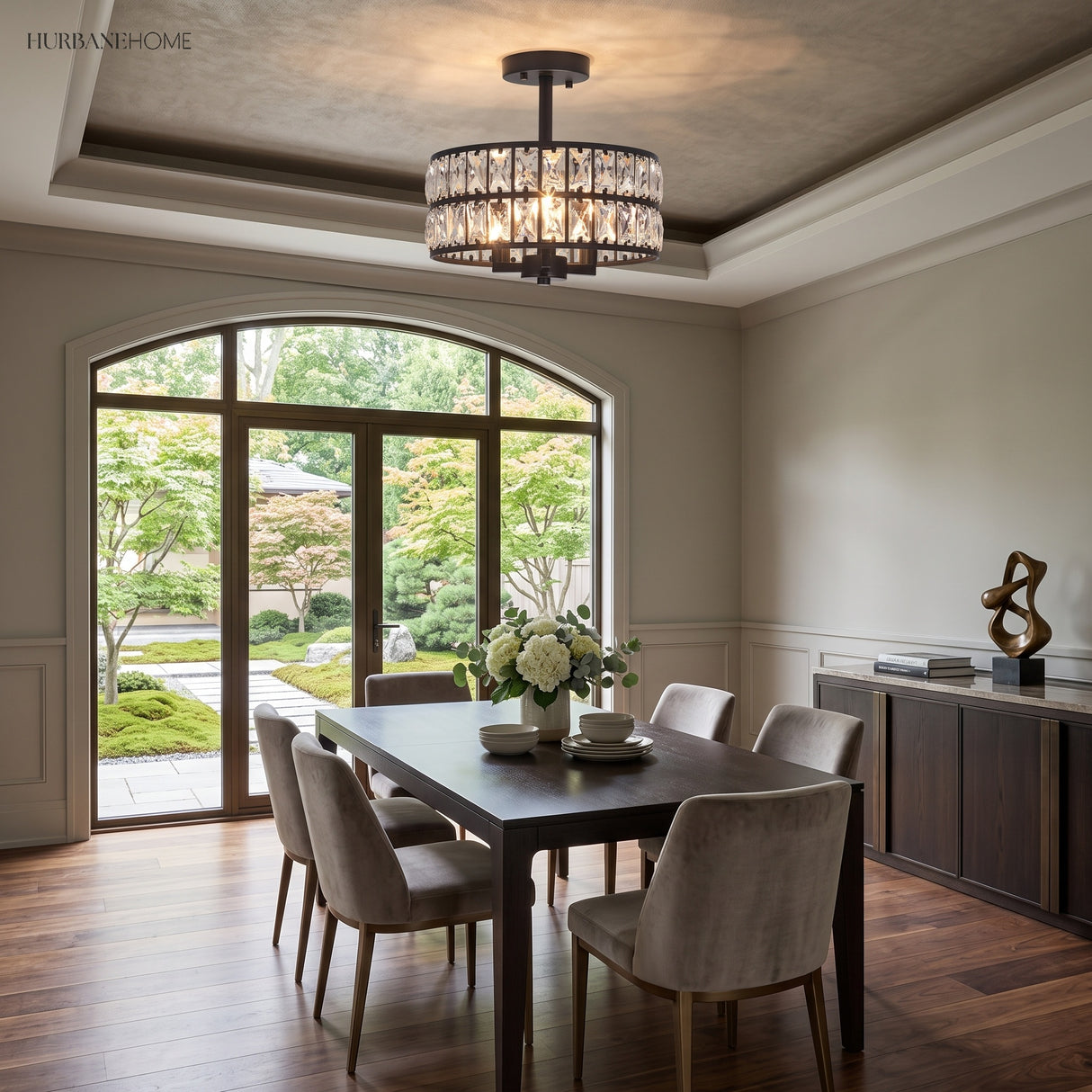 Black crystal drum ceiling light over a dining table by garden doors