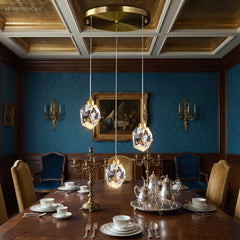 Three crystal pendants hung in a row above a dining table