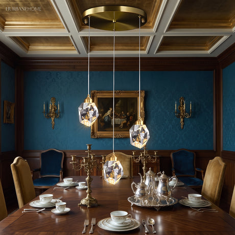 Three crystal pendants hung in a row above a dining table
