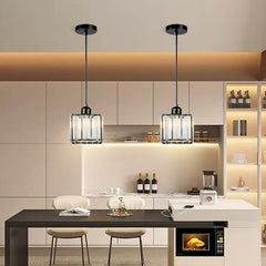 Two mini crystal pendants above a pale kitchen counter and bar stools