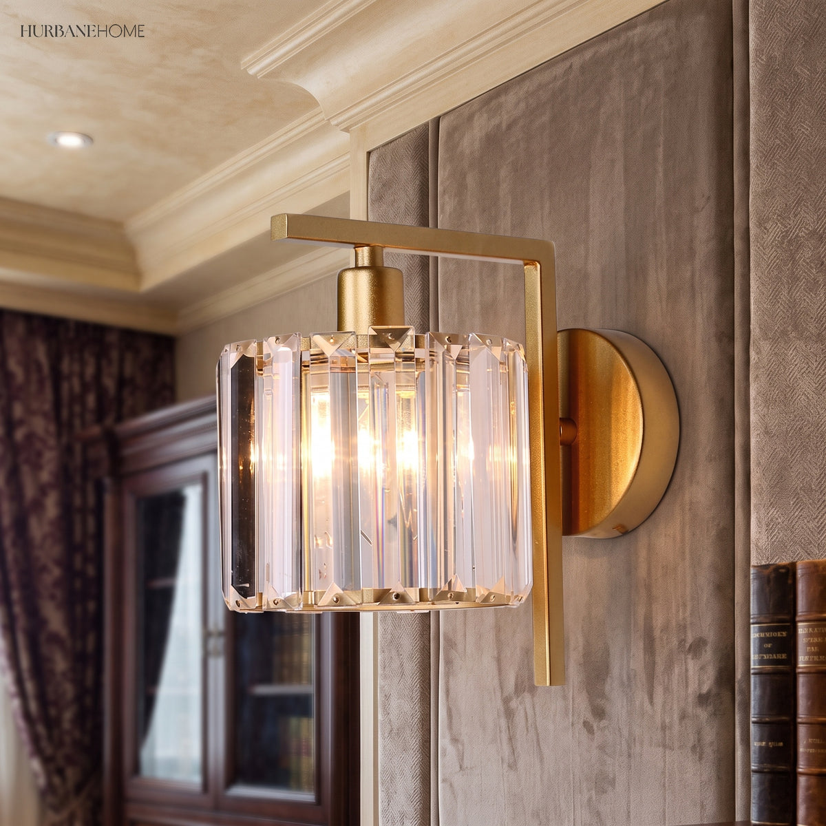 Crystal column sconce lit warm in a gilt panelled dining room