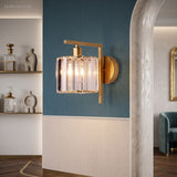 Crystal column sconce lit on a teal wall beside open shelving