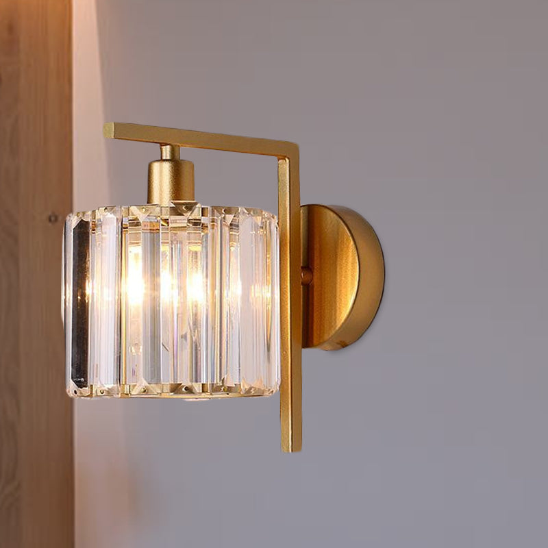 Crystal column sconce lit at an angle on a plain white wall