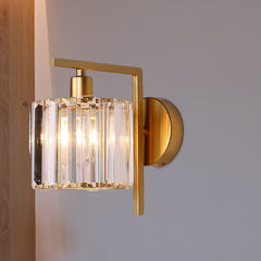Crystal column sconce lit at an angle on a plain white wall