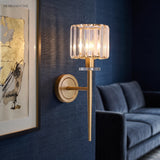 Crystal sconce on a blue wall beside a framed bird print