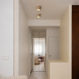 Cylinder ceiling light finish detail showing warm downward glow