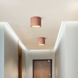 Cylinder ceiling light with textured composite shade and warm integrated LED glow