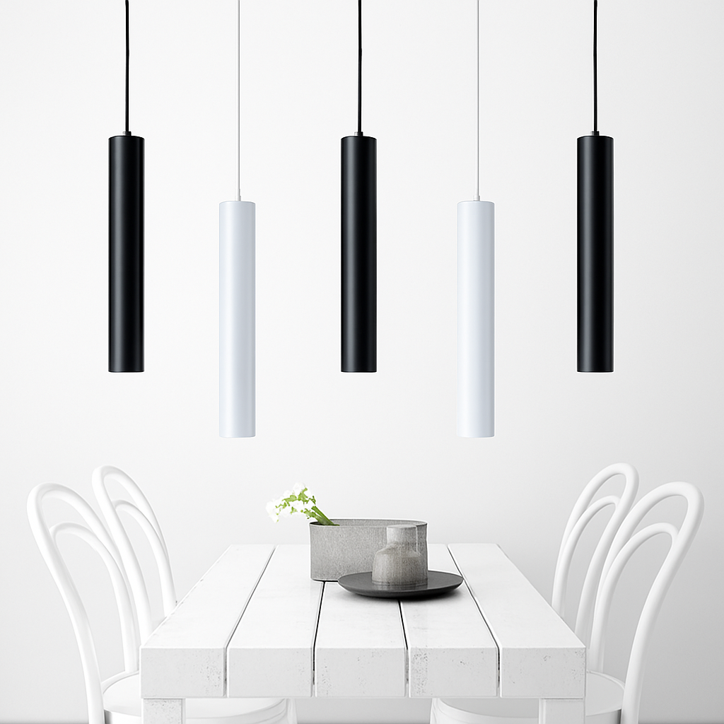 Black and white tube pendants above a white dining table