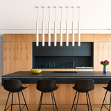 Row of white tube pendants above a timber kitchen island