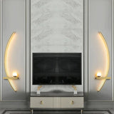 Arc wall light adding a warm accent to a moody dark living room
