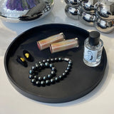 Decluttering bathroom counter with round silicone storage tray