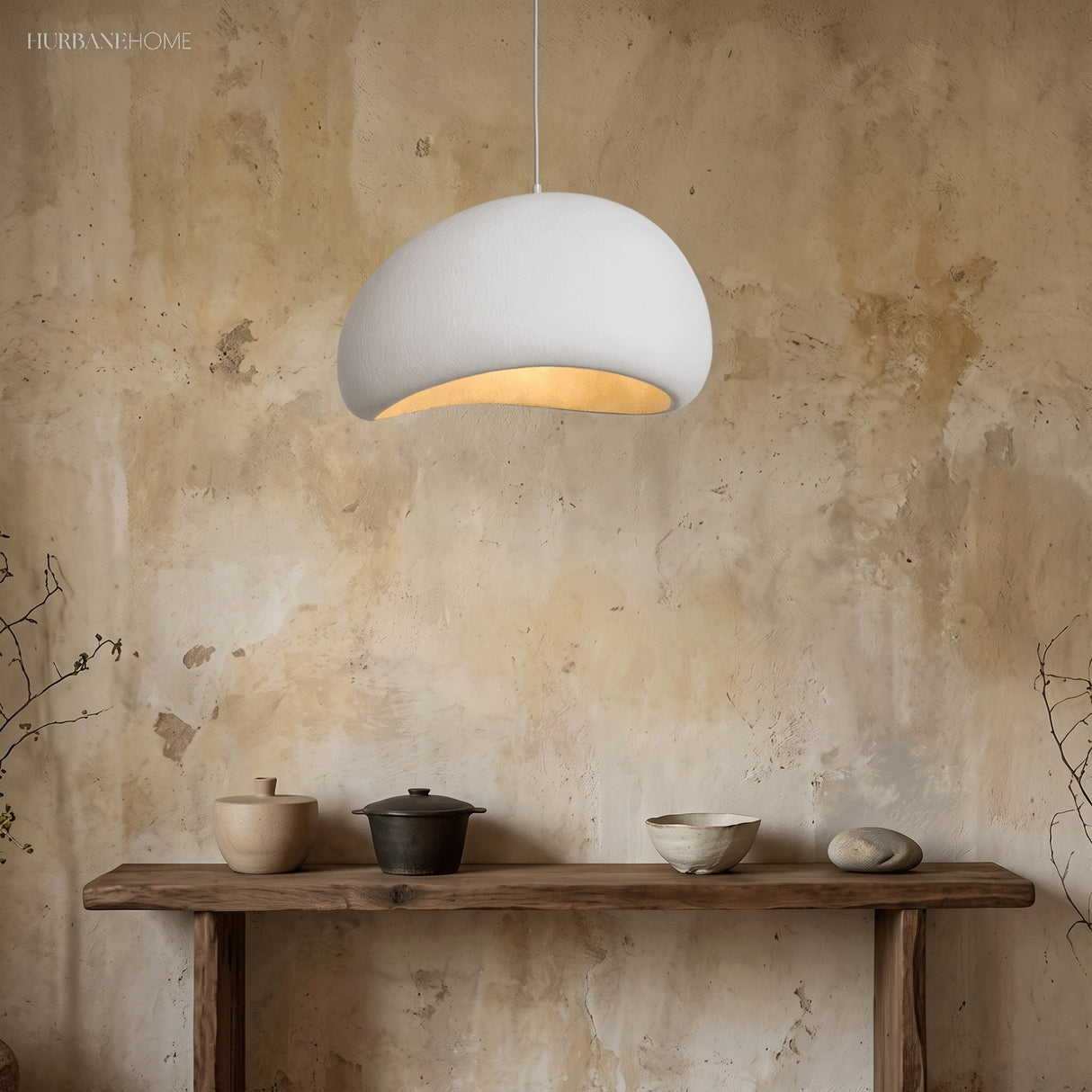 Single white dimmable pendant light glowing above a wooden console