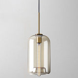 Studio shot of the tall amber cylinder shade lit from within
