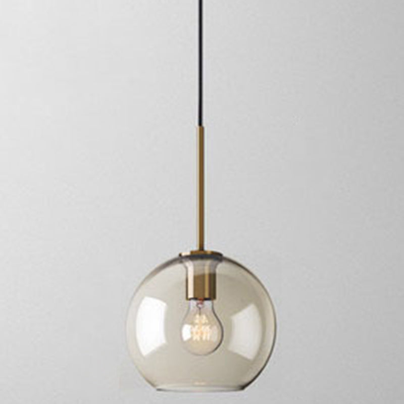 Studio shot of the small amber glass globe shade and brass cap