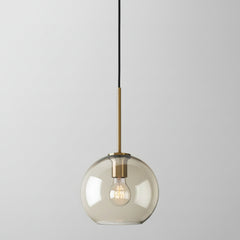 Studio shot of the small amber glass globe shade and brass cap