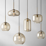 Six amber pendants in globe, urn and jar shapes hanging together