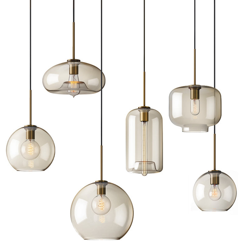 Six amber pendant shapes lined up on a plain white background