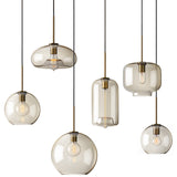 Six amber pendant shapes lined up on a plain white background