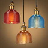All three gridded pendants lit together against a warm amber backdrop