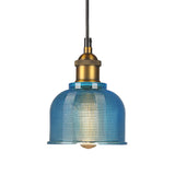 Blue gridded glass bell shade with a brass socket, shown unlit