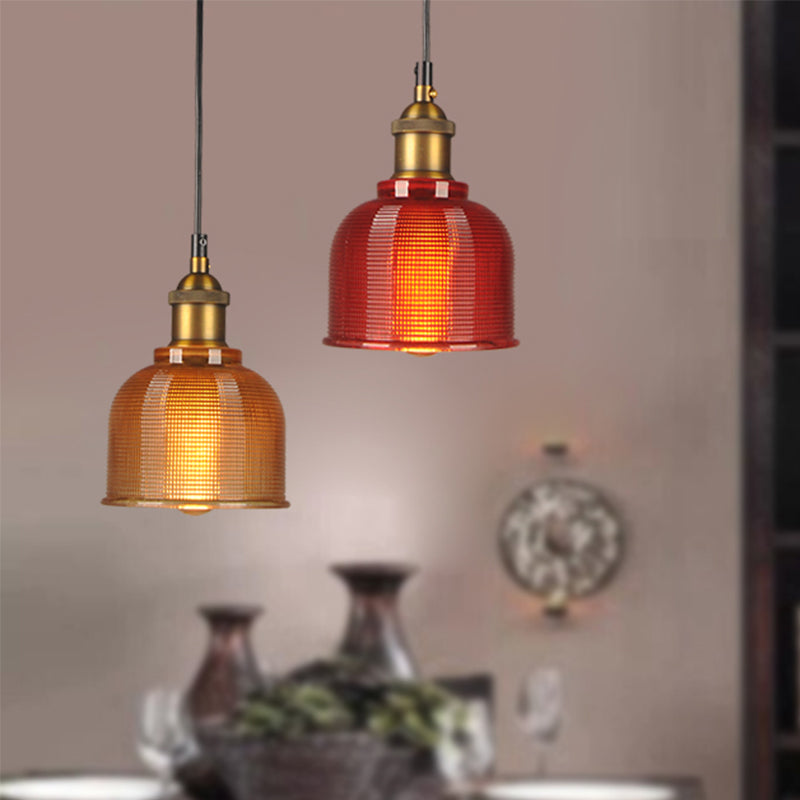 Orange and red gridded pendants above a table set with vases