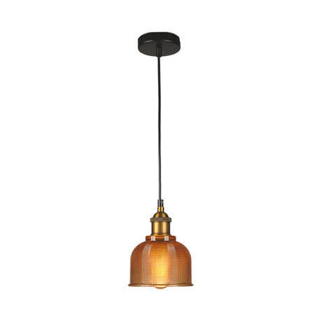 Orange gridded glass bell shade lit warm on a plain background