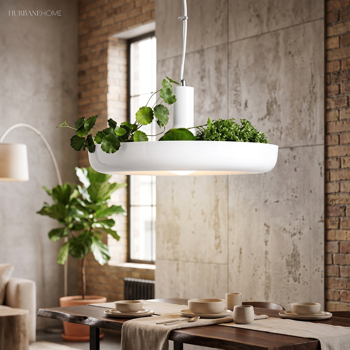 White ring planter pendant lit above a low dining table