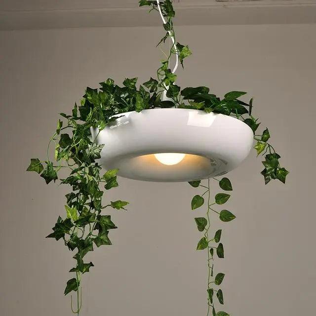 White ring planter pendant lit warm with ivy over the edge