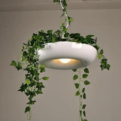 White ring planter pendant lit warm with ivy over the edge