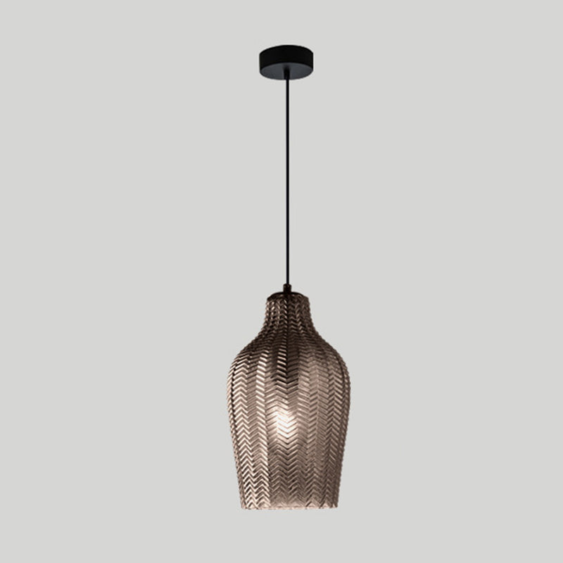 Smoke ribbed pendant with a tall bottle shade, shown on grey