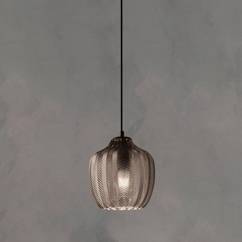 Smoke ribbed pendant with a rounded shade, lit against grey