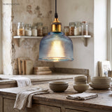 Blue ribbed glass pendant above a rustic kitchen counter