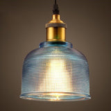 Blue ribbed glass bell pendant with a brass lamp holder