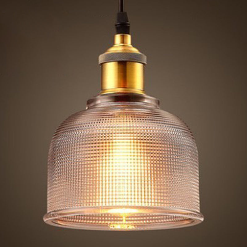 Clear ribbed glass pendant with warm light through the prisms