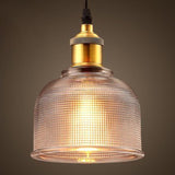 Clear ribbed glass pendant with warm light through the prisms
