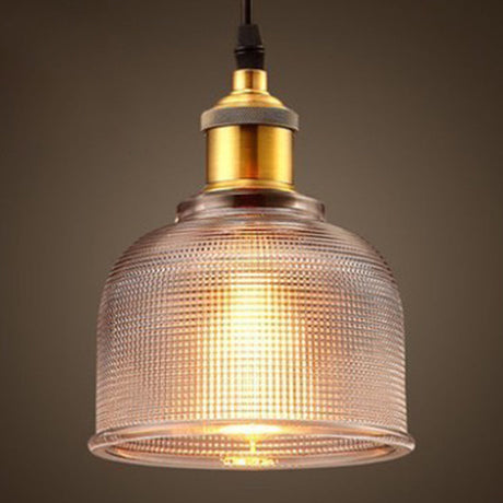 Clear ribbed glass pendant with warm light through the prisms