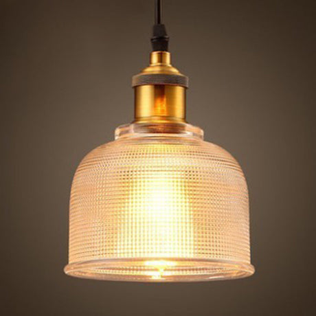 Clear bell pendant lit warm showing the ribbed glass texture