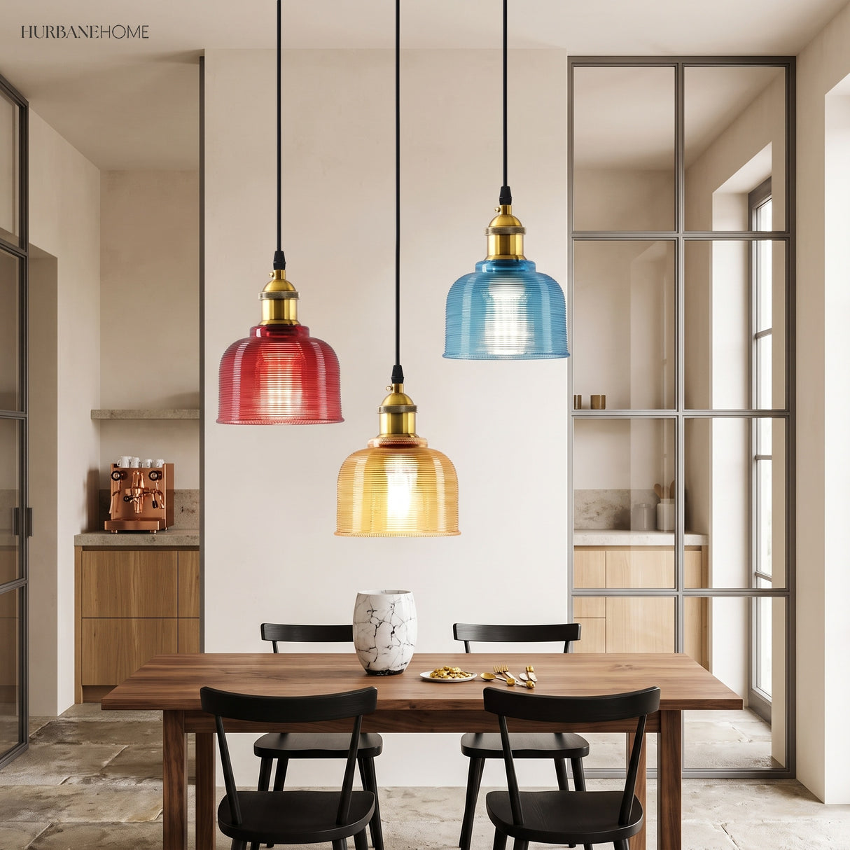 Red, amber and blue pendants above a wooden dining table